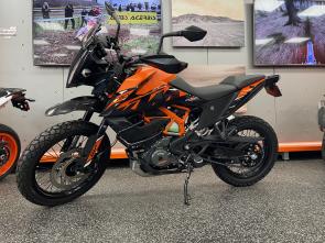 Conquer any terrain with confidence on this 2024 KTM 390 Adventure, now upgraded with a high fender kit for enhanced off-road capability and aggressive rally styling. Built for riders who crave adventure without compromise, the 390 Adventure features a punchy 373cc single-cylinder engine, lightweight chassis, and long-travel WP APEX suspension for nimble handling on both pavement and dirt. The high fender not only adds clearance in muddy or rugged conditions but also gives the bike a bold, Dakar-inspired look. With ride-by-wire throttle, switchable ABS, and a TFT display with smartphone connectivity, this versatile machine is ready to take you from city streets to remote trails with ease.